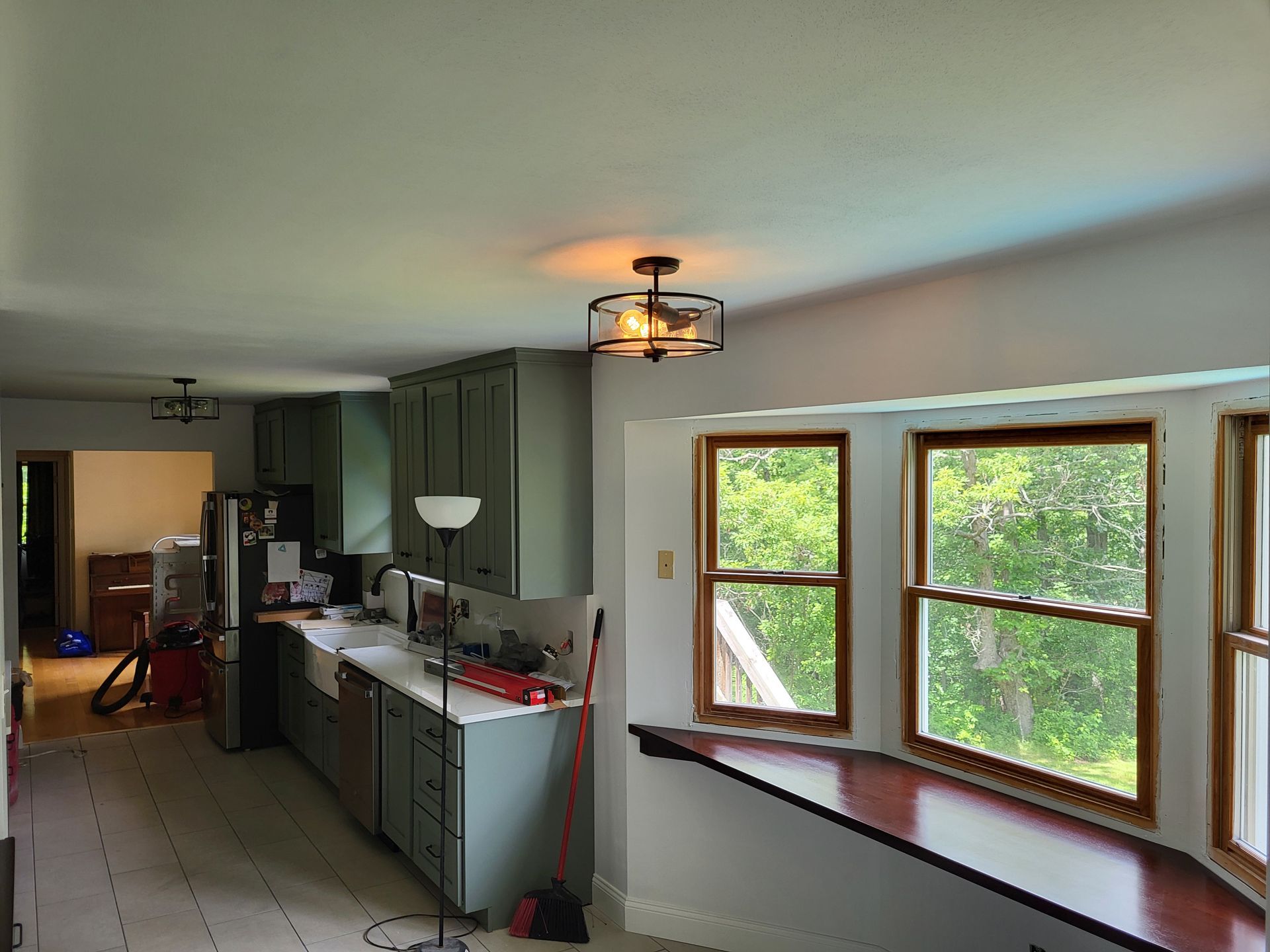 A kitchen with a lot of windows and a ceiling fan