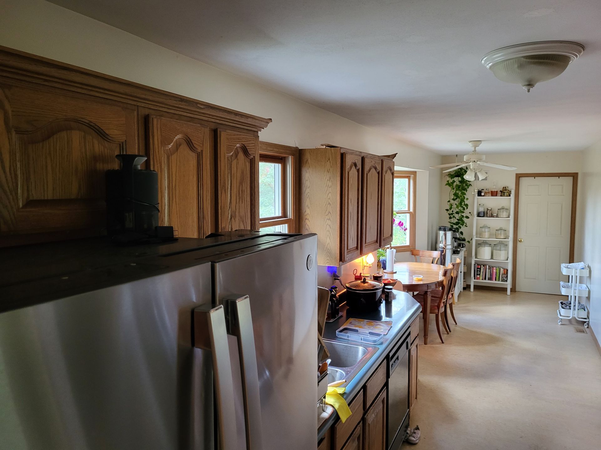 A kitchen with stainless steel appliances and wooden cabinets.
