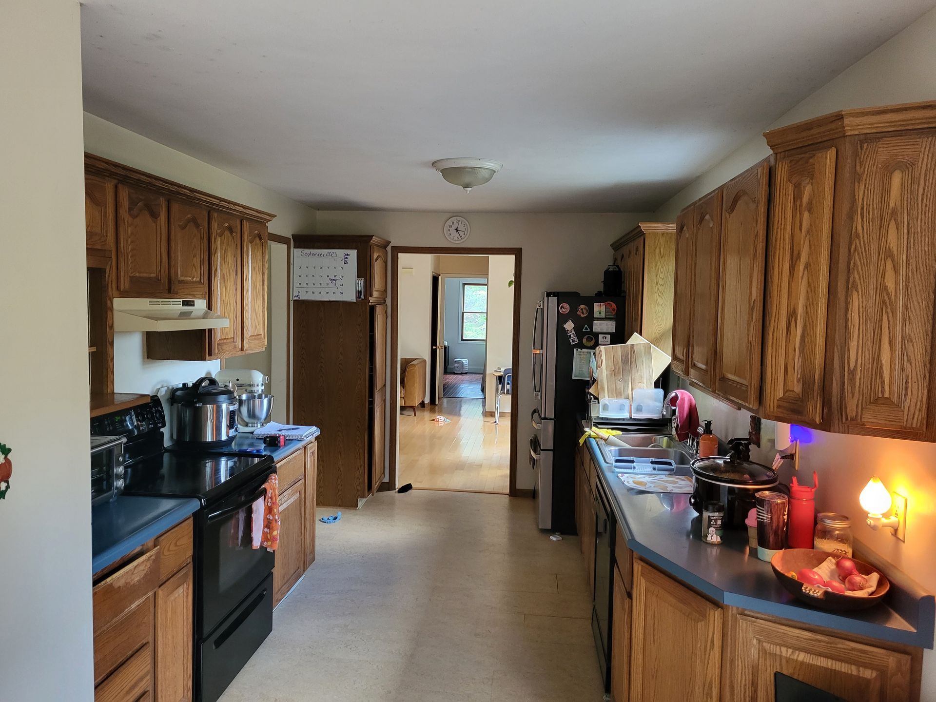 A kitchen with wooden cabinets and black appliances