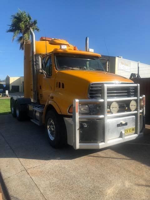 Big Yellow Colour Semi Truck In Front Of House — Mid North Coast Heavy Vehicle Repairs In Wauchope, NSW