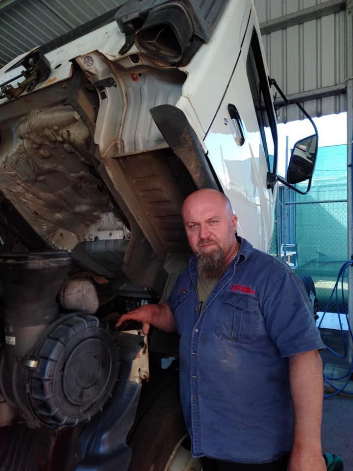 White Truck Under Repair With The Mechanic Standing Near It — Mid North Coast Heavy Vehicle Repairs In Wauchope, NSW