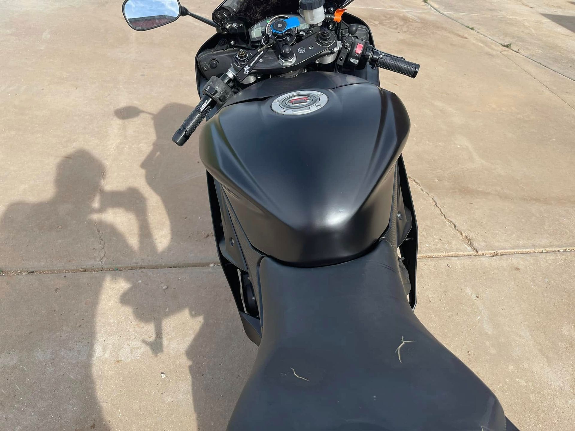 A black motorcycle is parked on the side of the road