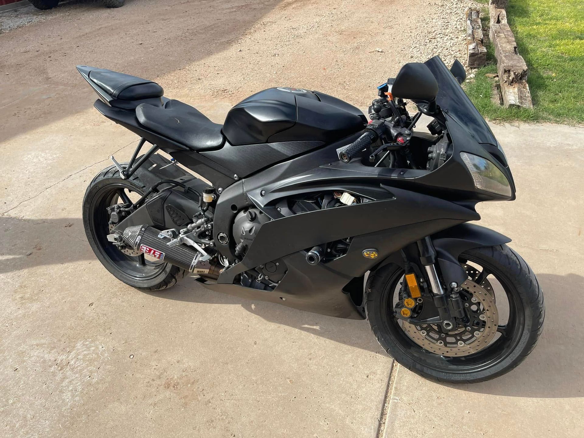 A black motorcycle is parked on the side of the road