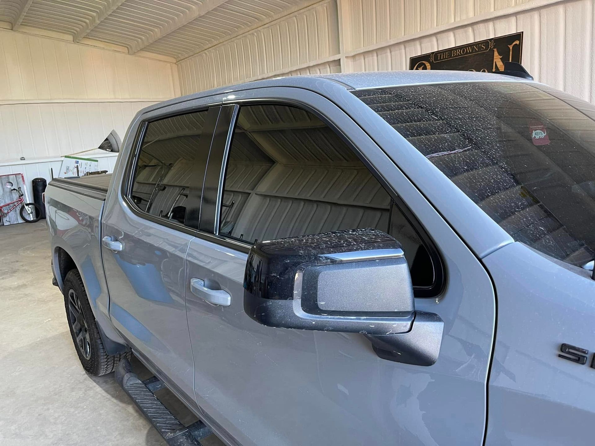 A gray truck is parked in a garage.