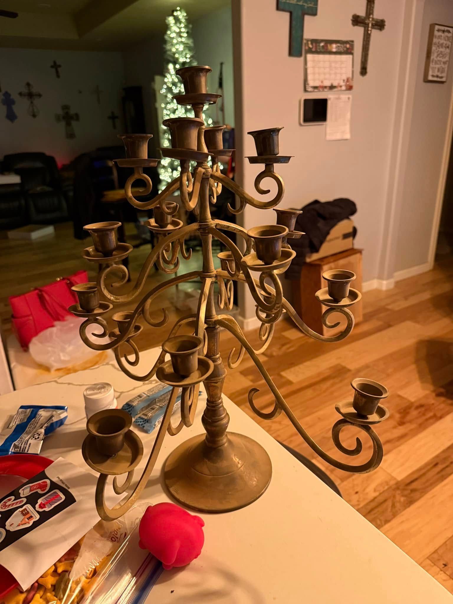 A candle holder is sitting on a table in a living room.