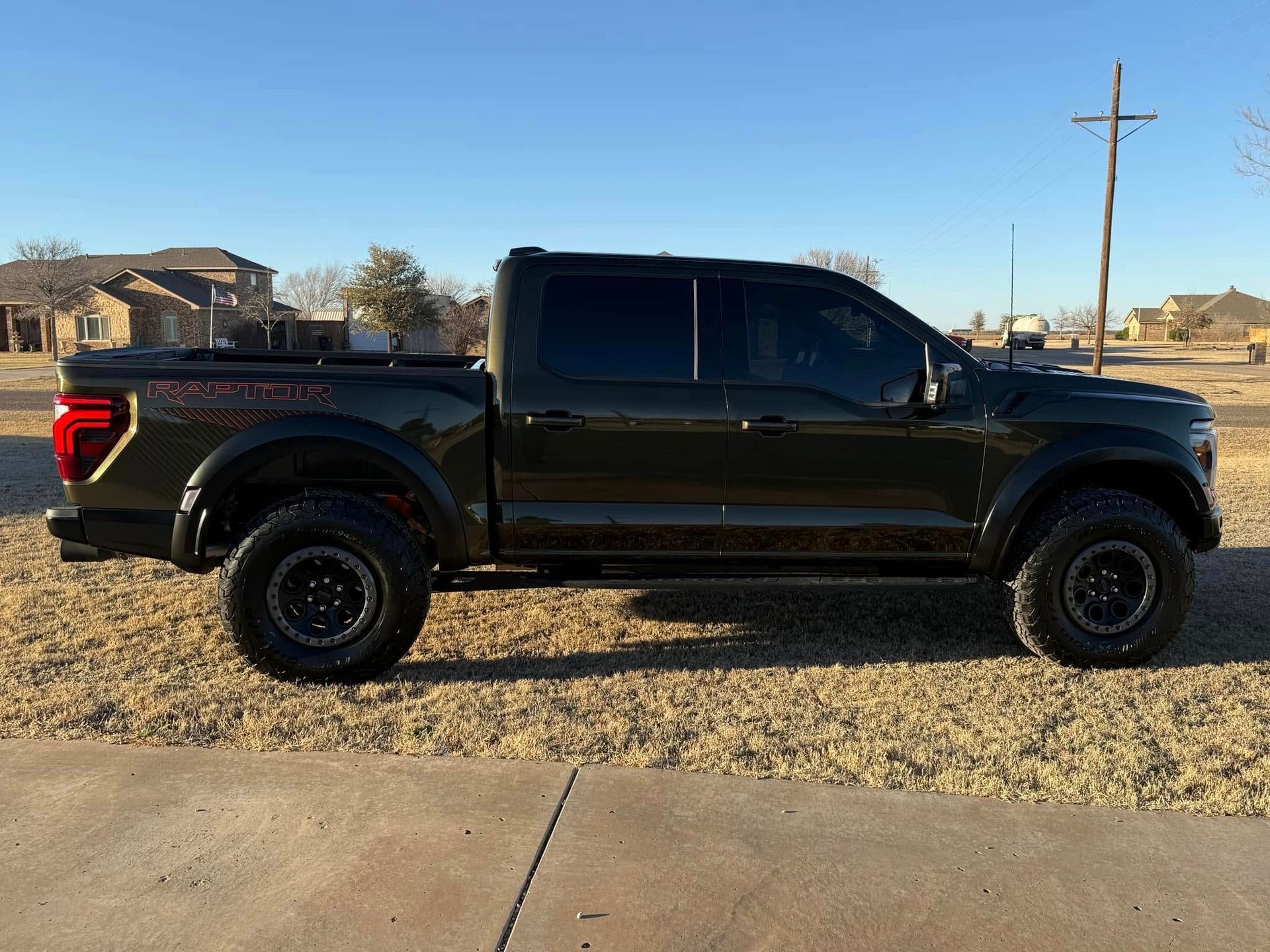 A black pickup truck is parked on the side of the road.