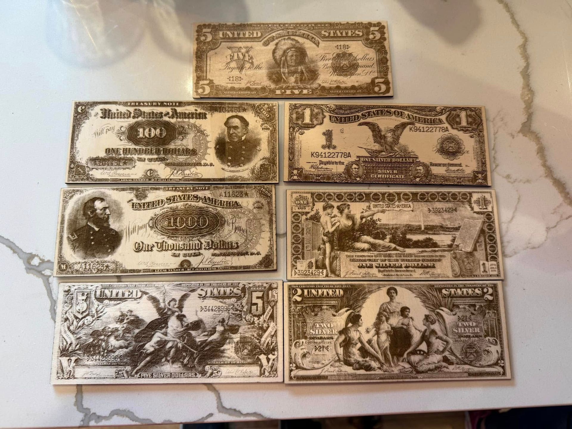 A bunch of old money is sitting on a counter.