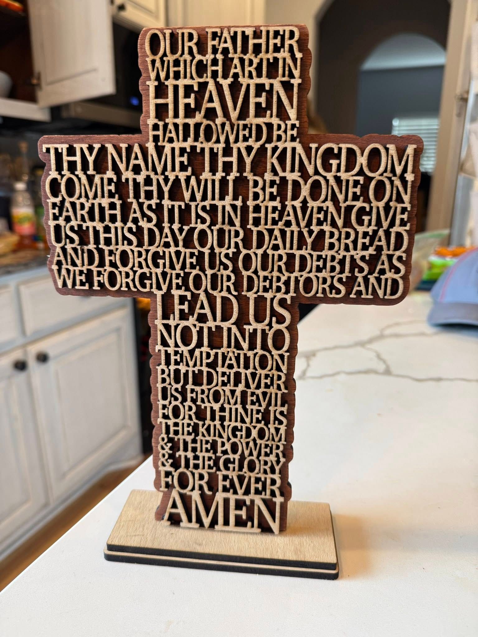 A wooden cross with the lord 's prayer on it