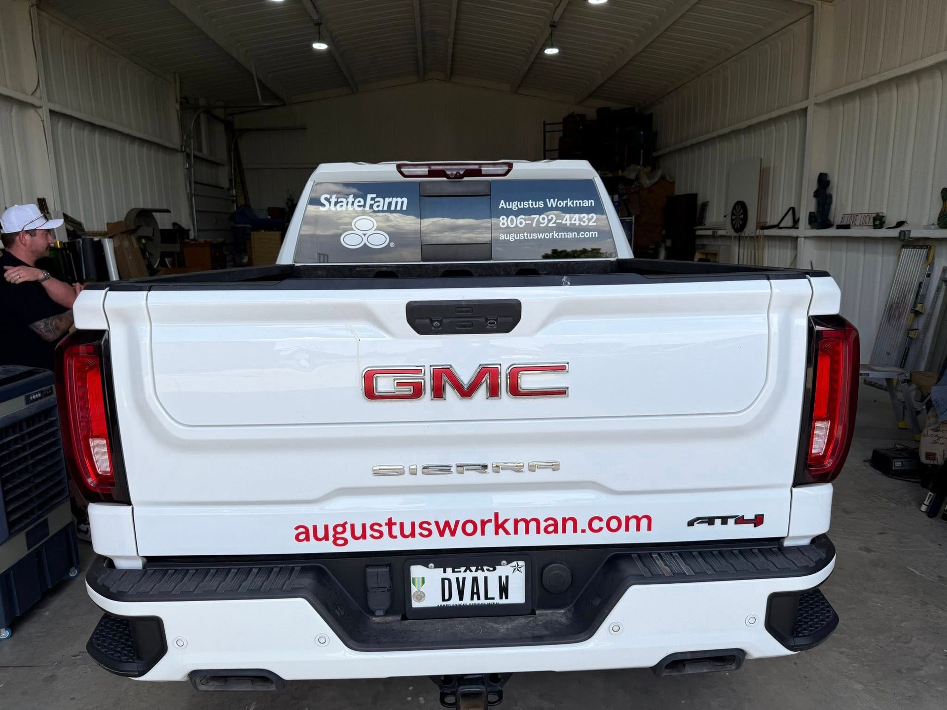 A white gmc truck is parked in a garage.