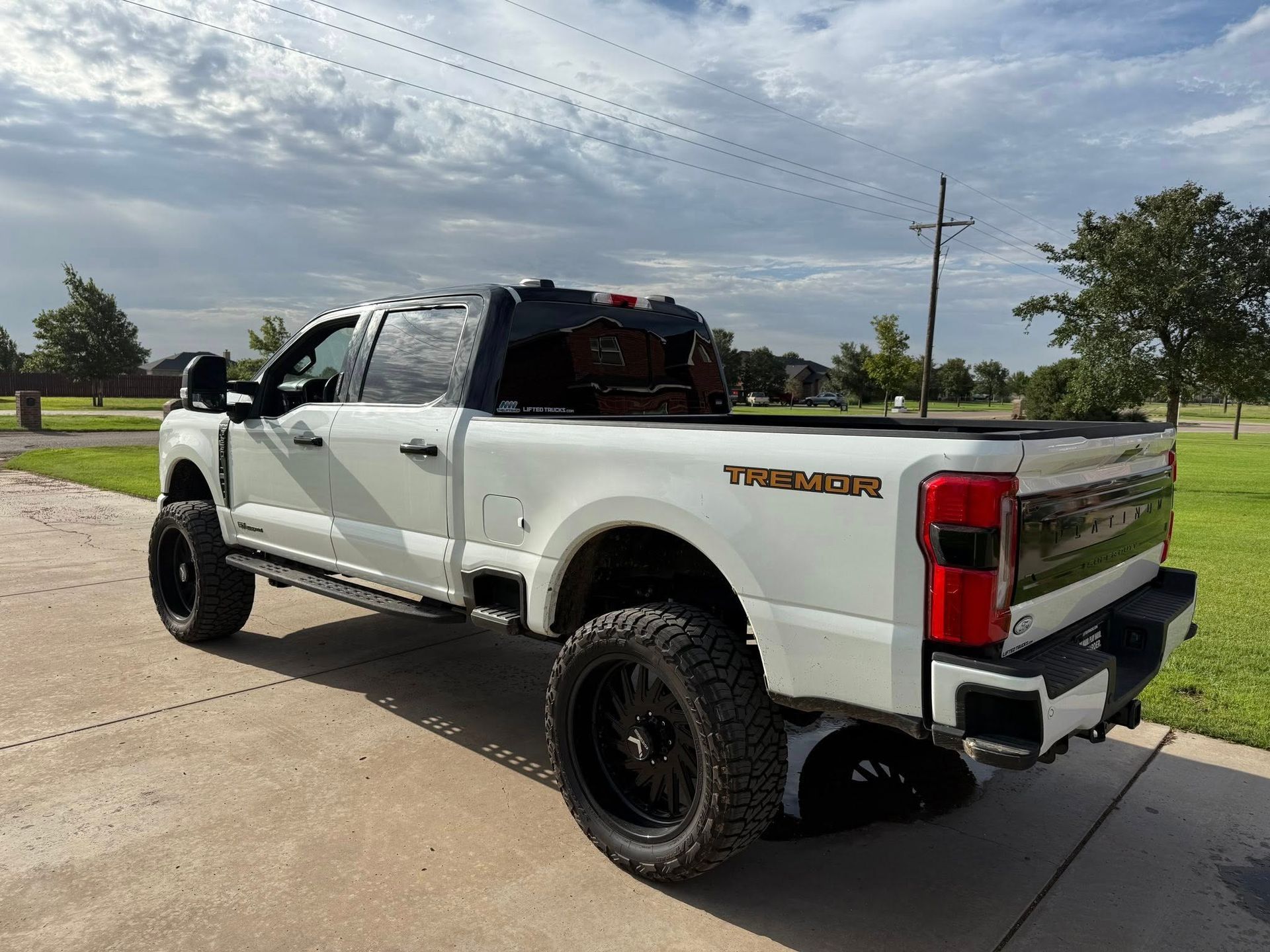 A white truck is parked on the side of the road.