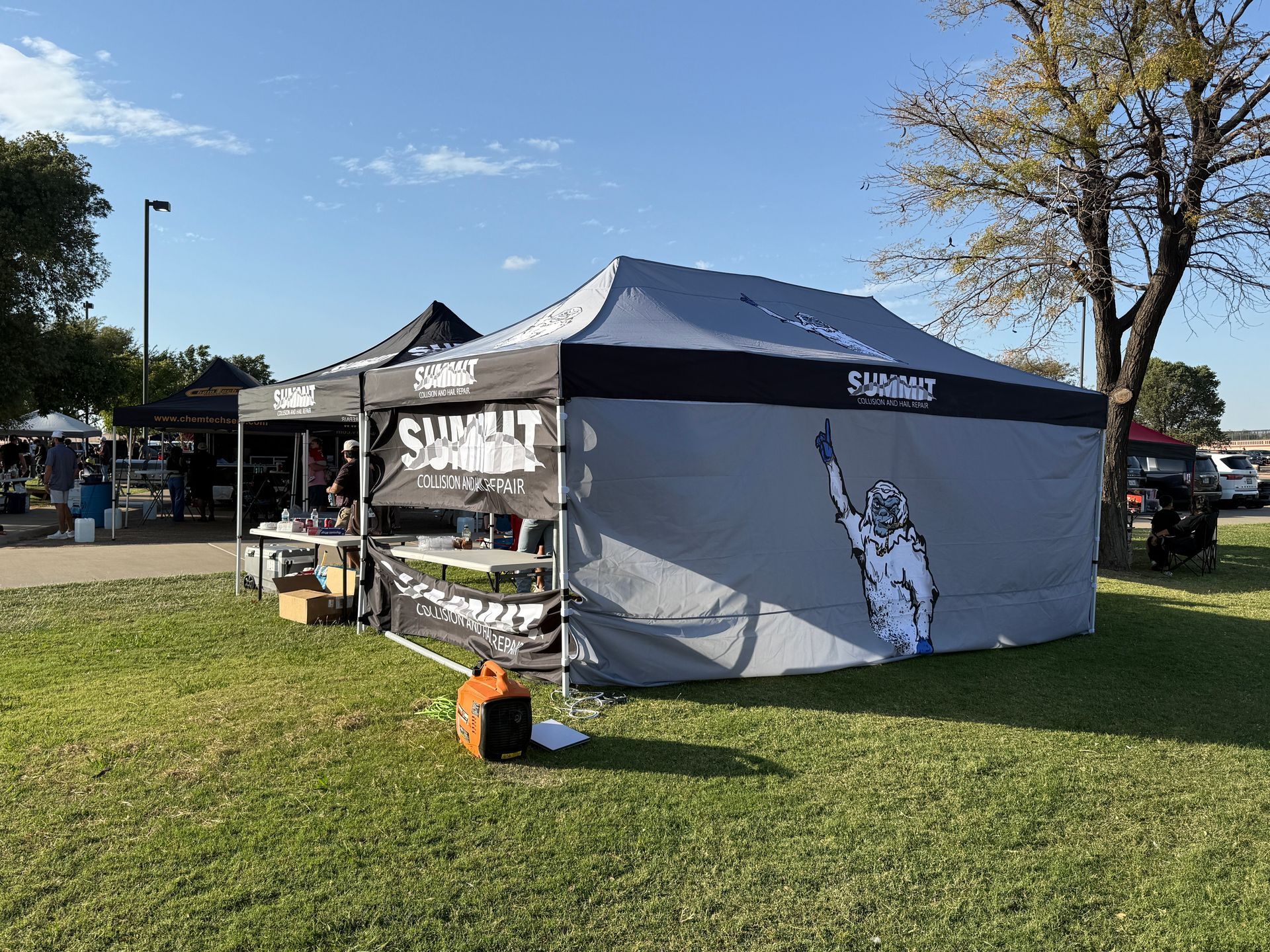 A yellow excavator is sitting on top of a pile of gravel.