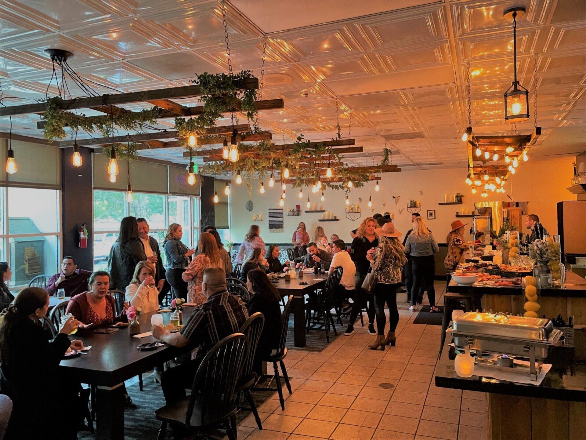 Guests mingle and share food and drink at a private party held at The Nook in Temecula, CA hosted by Wine Country Catering