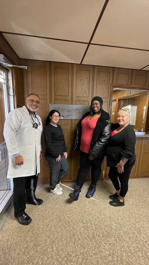 A group of people standing next to each other in a room.