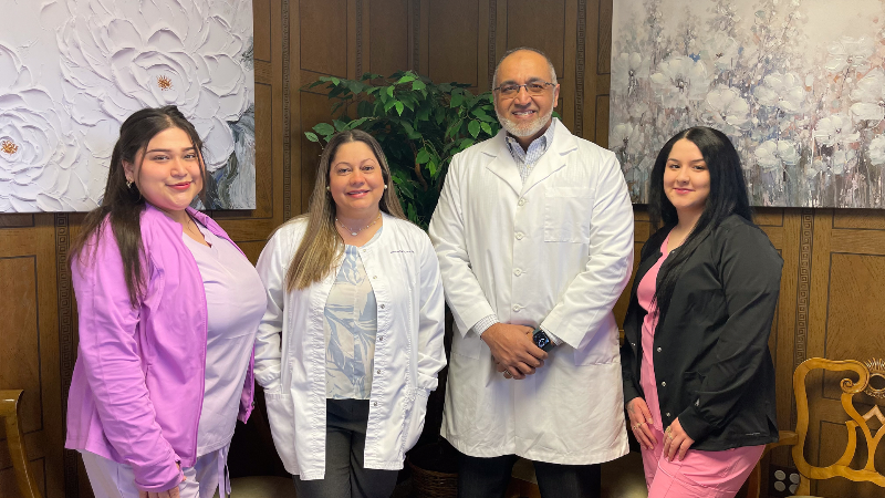 A group of doctors and nurses are posing for a picture.