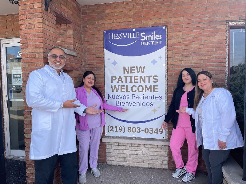 A group of people standing in front of a sign that says new patients welcome.