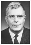 A black and white photo of a man in a suit and tie.