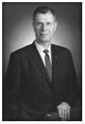 A black and white photo of a man in a suit and tie.