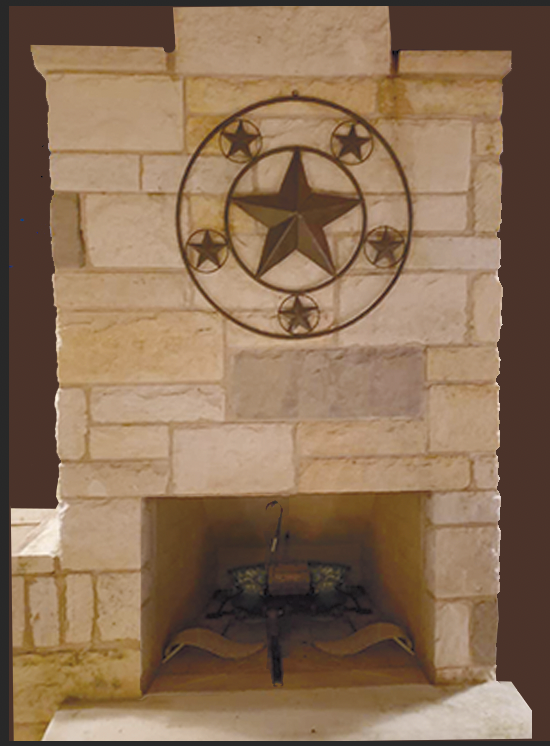 Stone fireplace with metal star decoration.