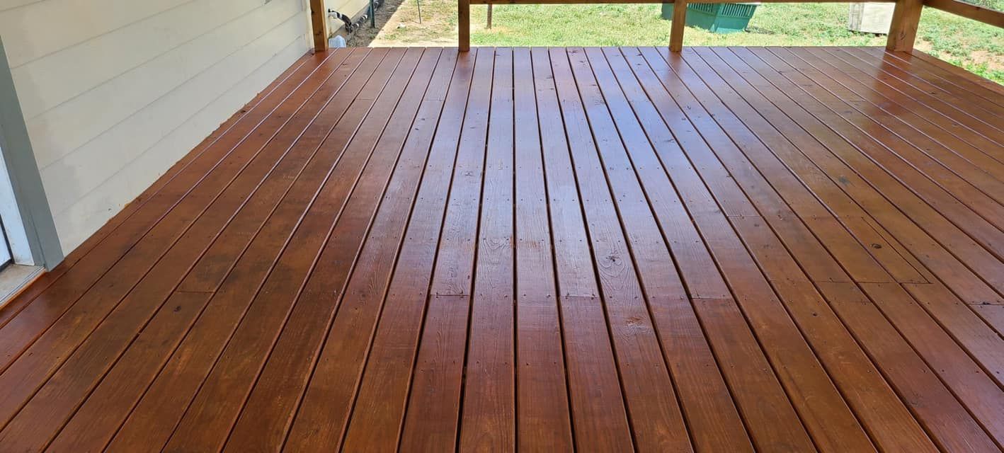 Wooden deck with a glossy finish, likely recently stained.