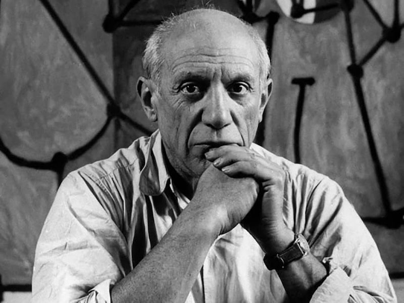 Pablo Picasso, portrait, hands clasped, serious expression, light shirt, abstract art background.