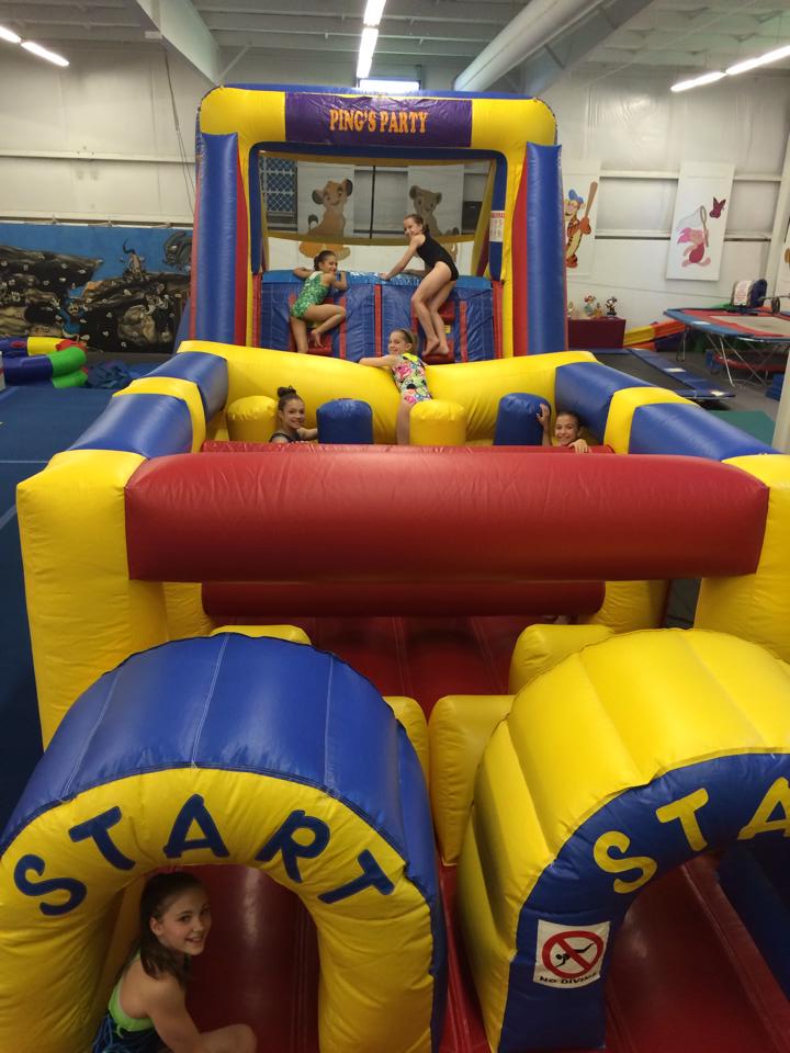 a group of children are playing in a bouncy house .