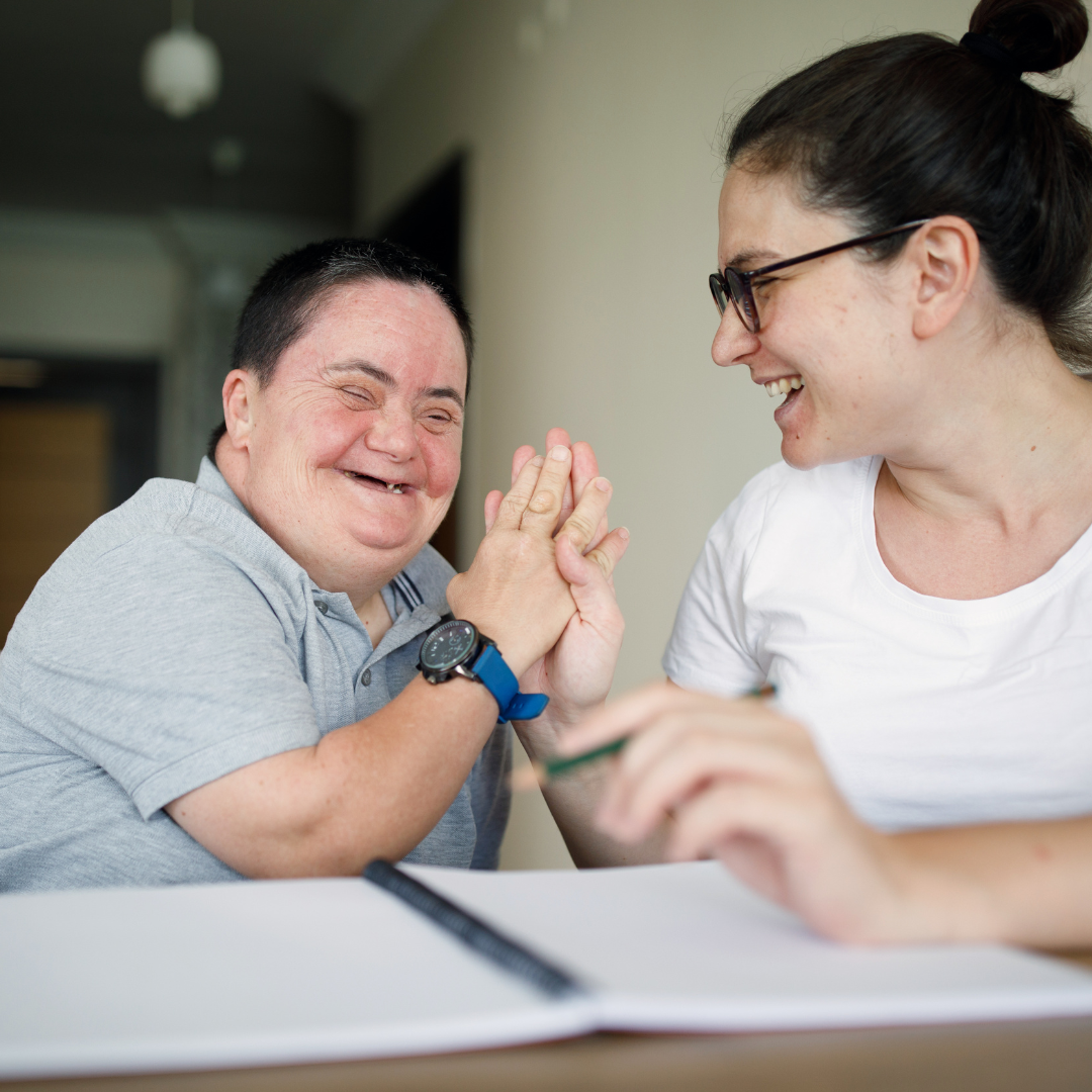 autistic person laughing with caregiver