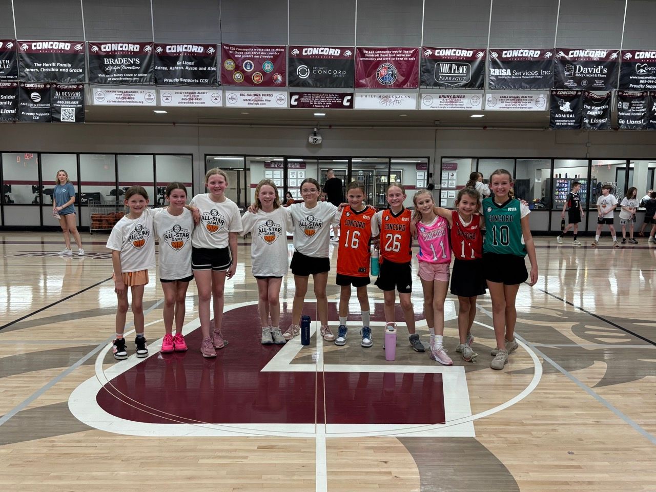 Baseball player sliding into home plate, catcher in front. Blue and gold uniforms, action shot.