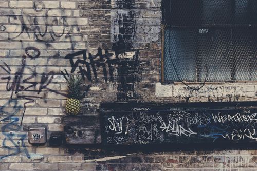 A brick wall with graffiti