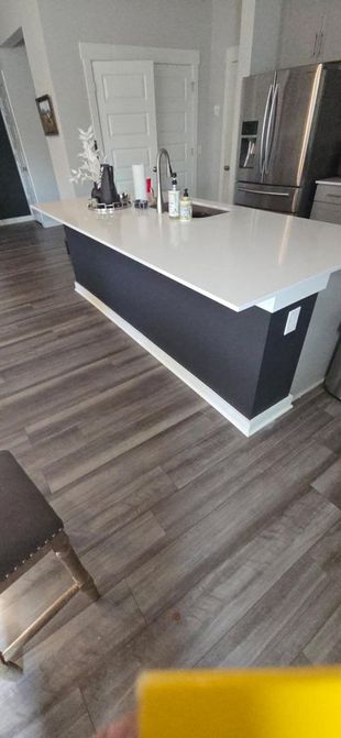 A kitchen with a large island and a sink.