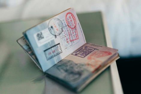 A close up of an open passport on a table.