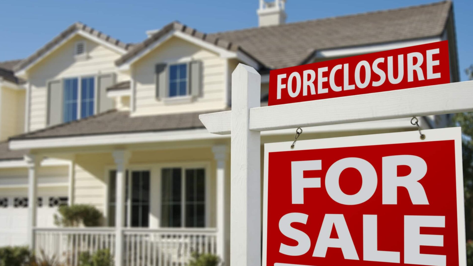 A house with a foreclosure sign in front of it