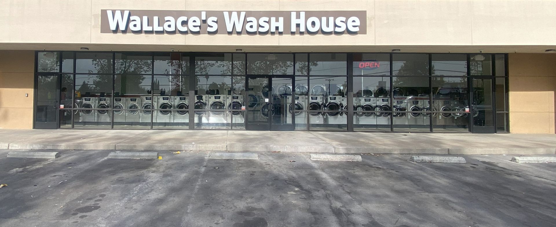 wallace 's wash house is a laundromat with a lot of windows | Fresno, CA | ALCO Services