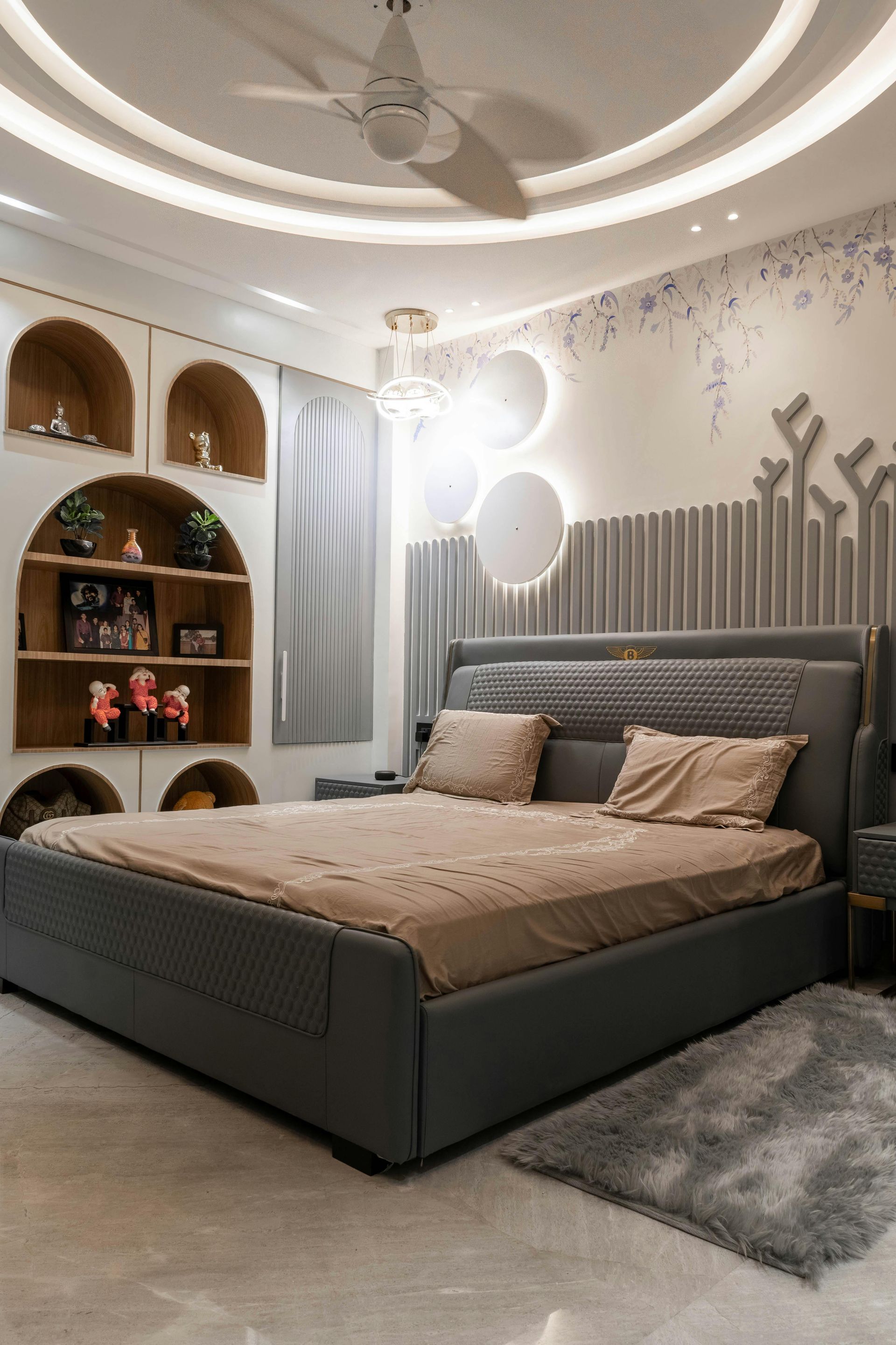 A bedroom with a large bed and a ceiling fan.