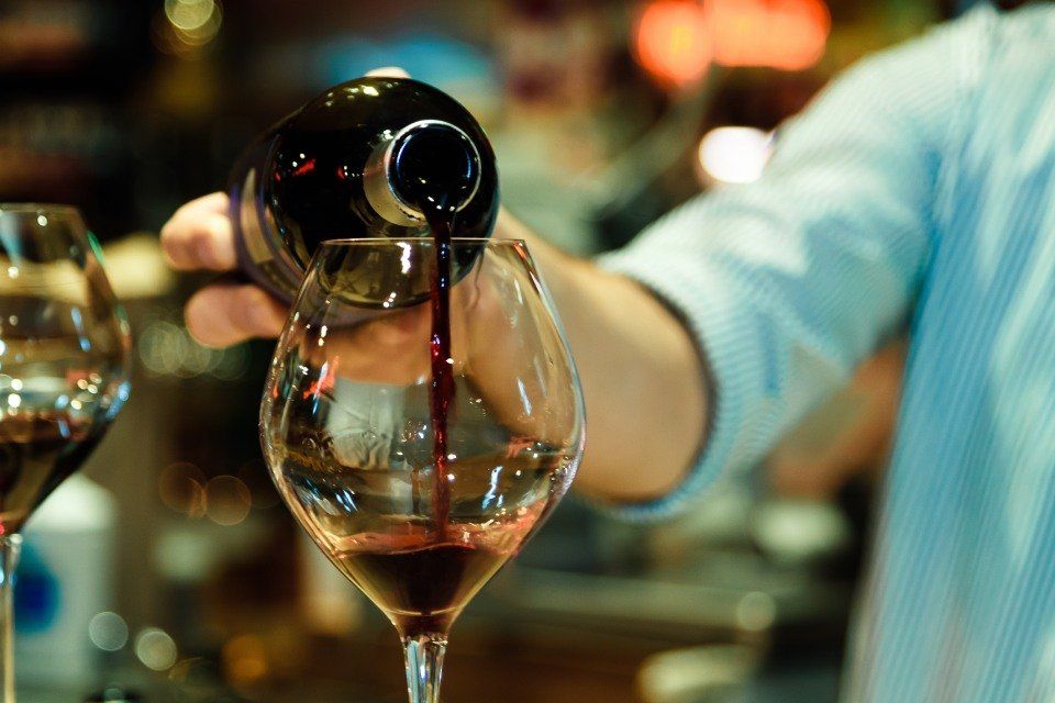 red wine being poured into a glass