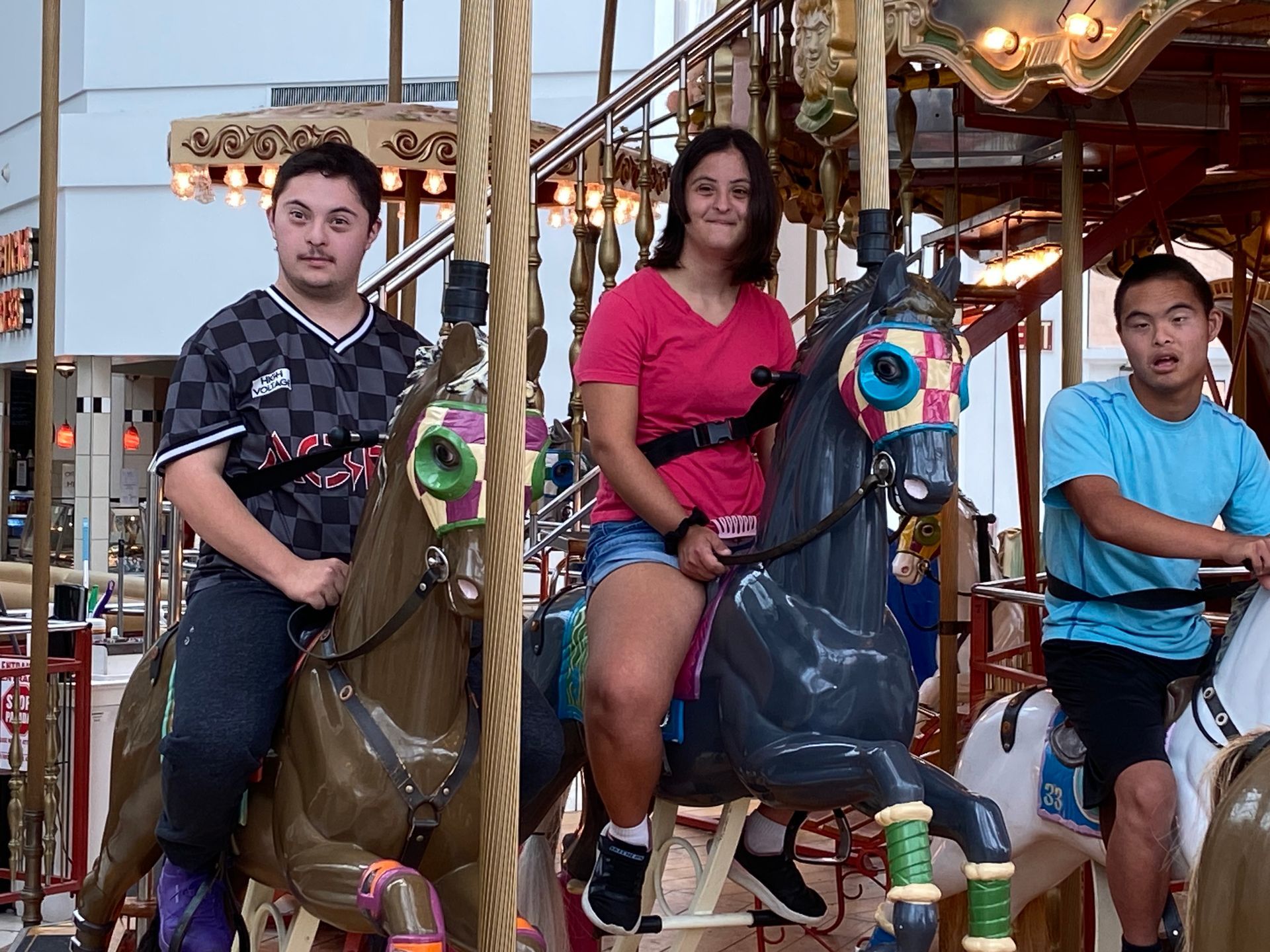 A group of people standing on a sidewalk in a park