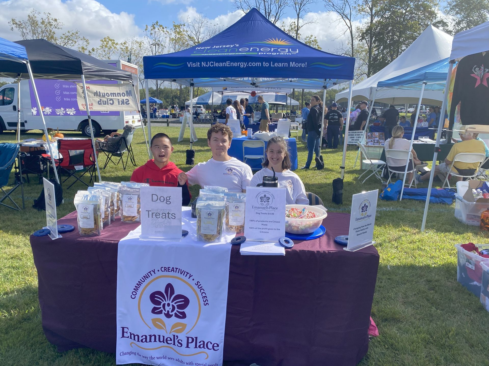 A group of people wearing aprons are posing for a picture in front of a building.