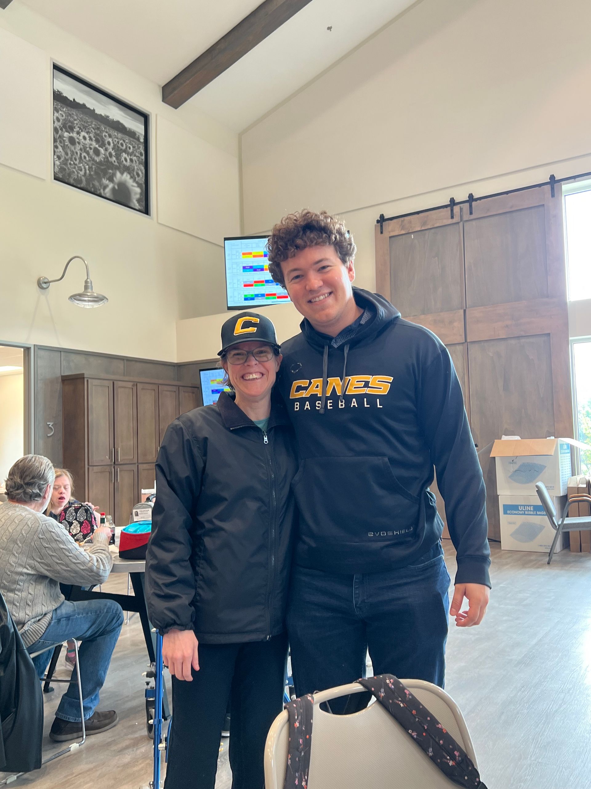 A man and a woman are posing for a picture in a room.