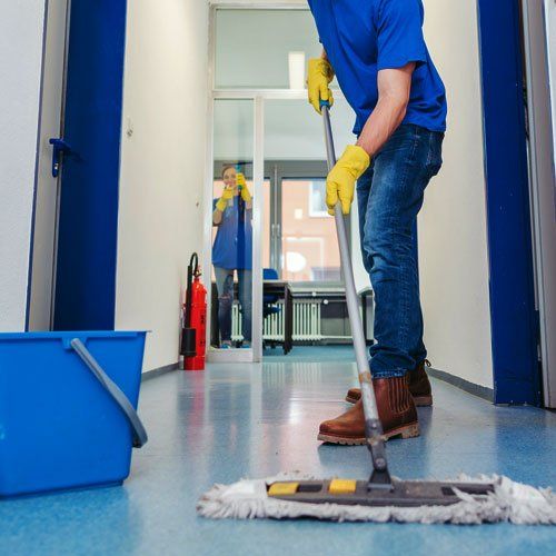 Cleaner Man Mopping the Floor — Beaver Falls, PA — Cline Cleaning & Restoration