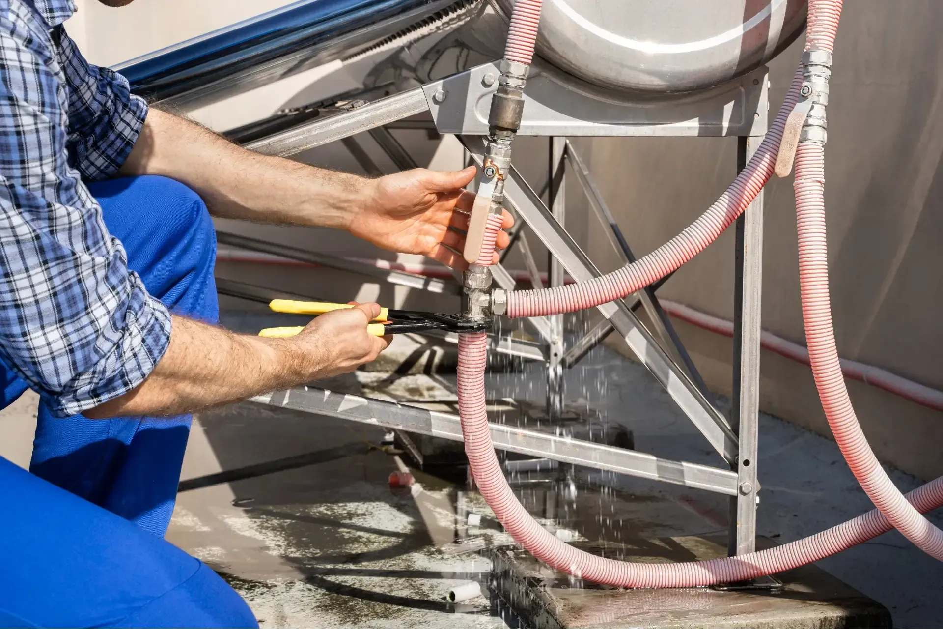 A plumber is fixing a sink pipe with a wrench.
