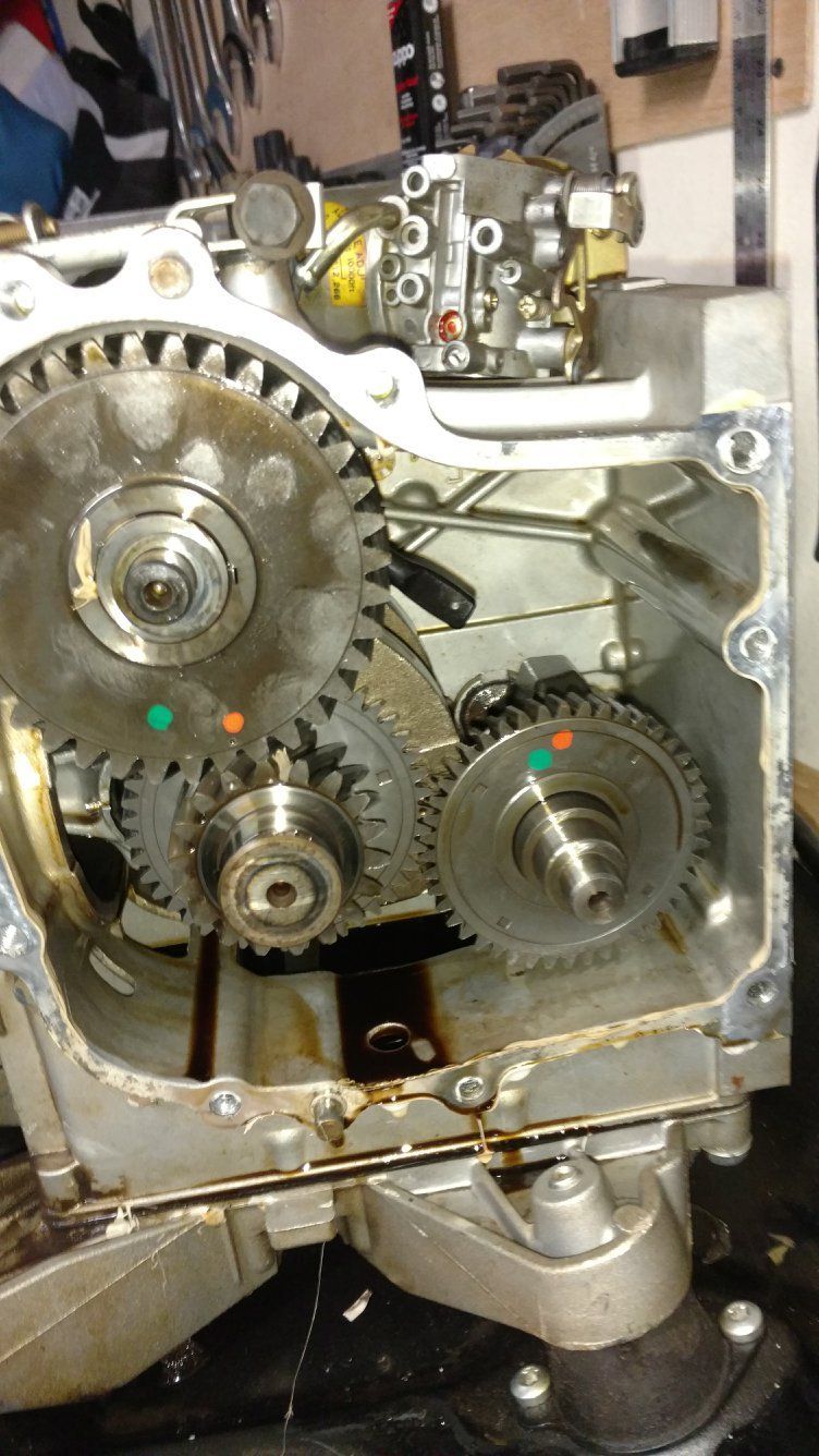 Engine gears exposed, with green and orange alignment marks visible.