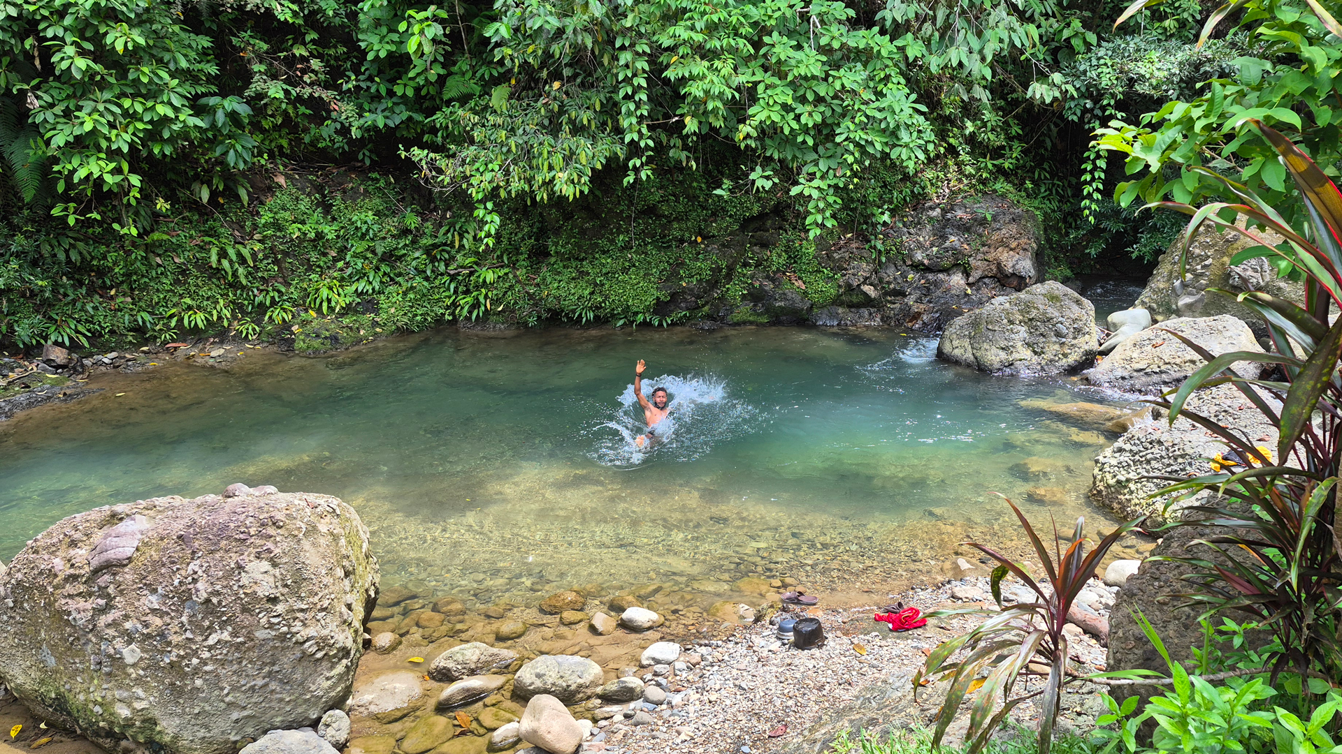 Person swimming in a water hole along the Kokoda track in Papua New Guinea