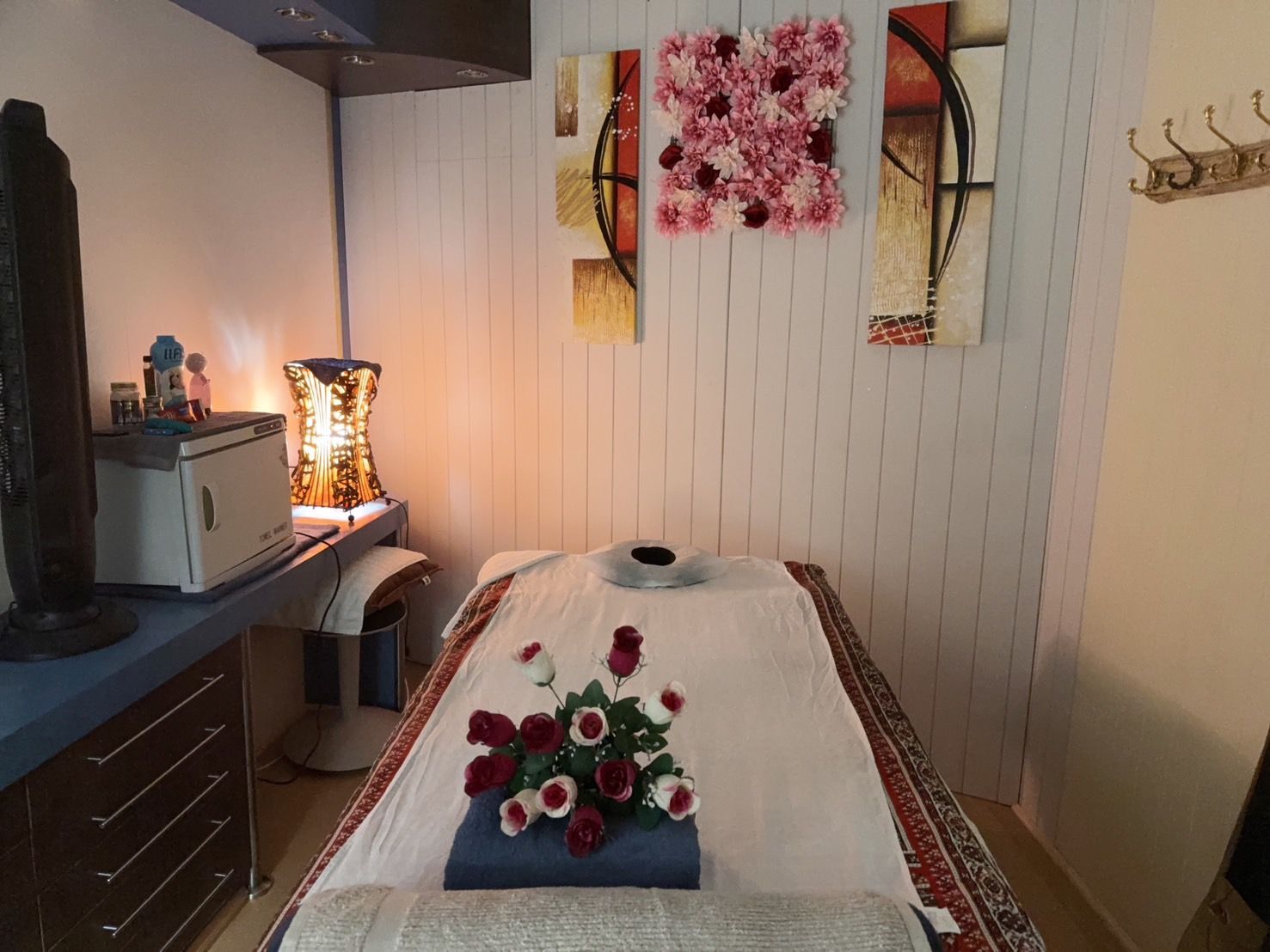 A massage table in a room with flowers on it at Sarah's Thai Massage Paradise Point.