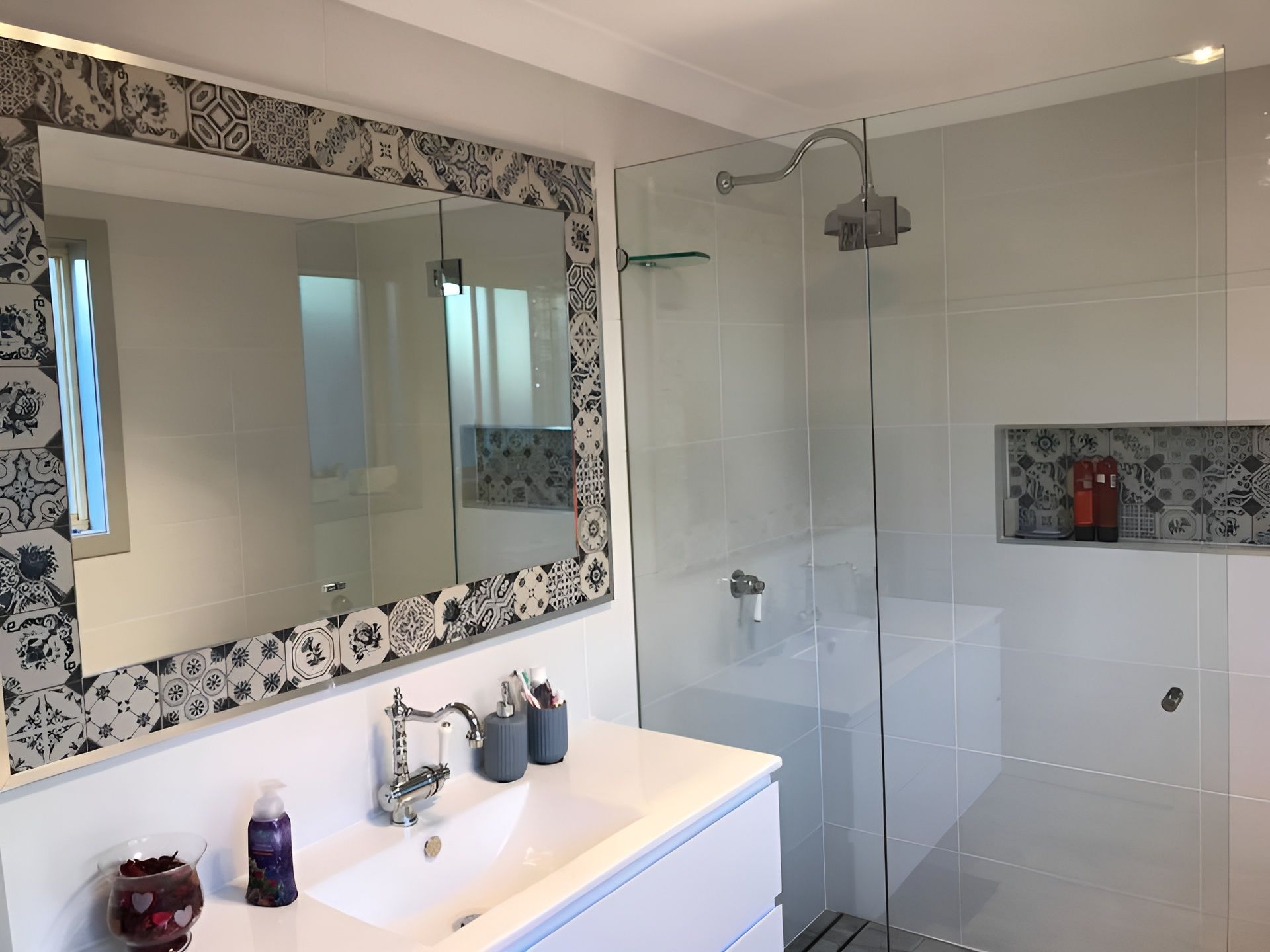 Bathroom with A Mirror, White Vanity, Glass Shower, and Patterned Tile Accents — Master Glass & Glazing in Newcastle, NSW