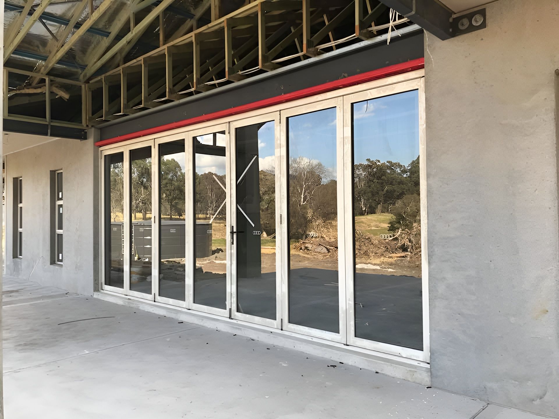 Exterior View of A Building with Large, Folding Glass Doors — Master Glass & Glazing in Merewether, NSW