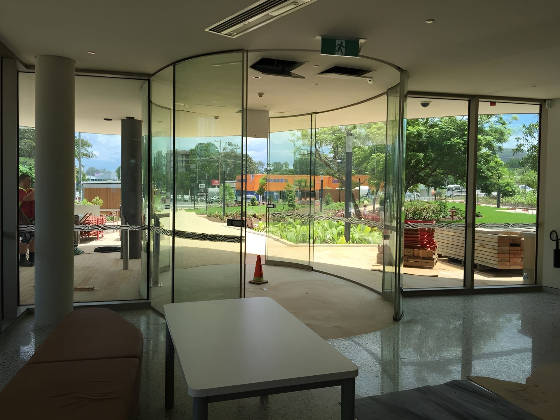 Interior with Curved Glass Wall, Looking out To Garden and Building — Master Glass & Glazing in Charlestown, NSW