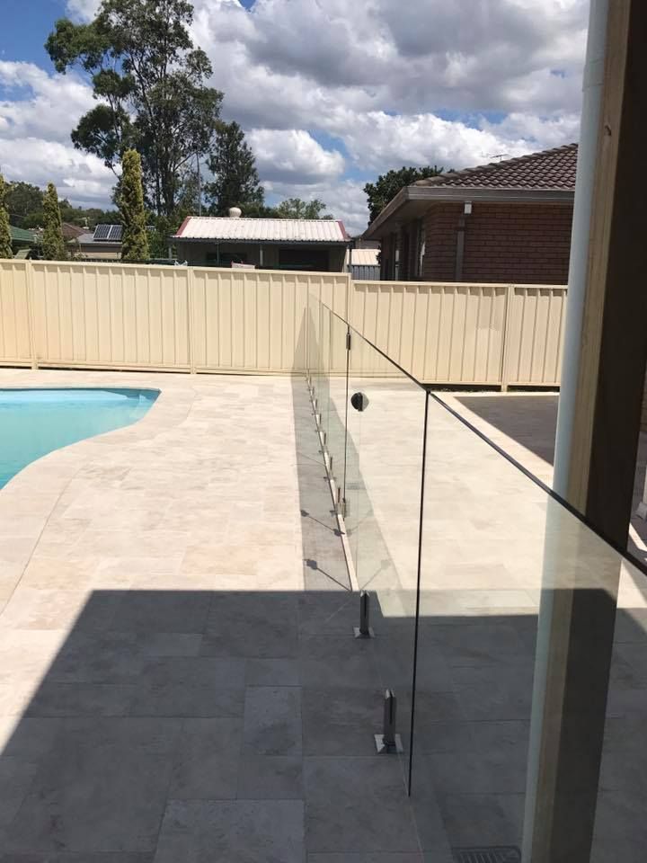 Glass Pool Fence on Patio Overlooking Pool and Yard — Master Glass & Glazing in Toronto, NSW