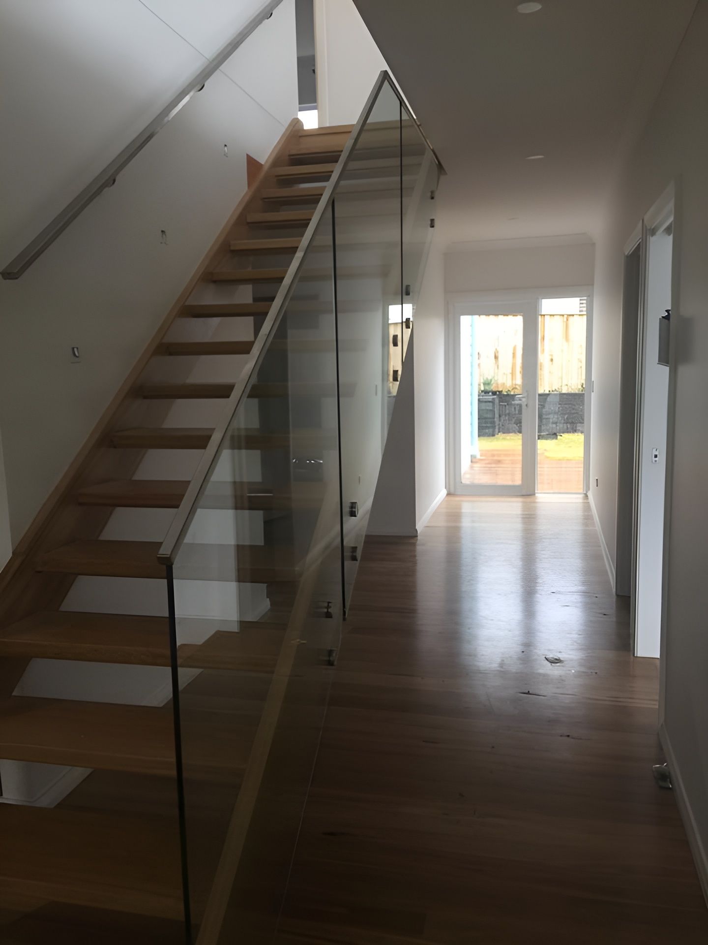 Staircase with Glass Railing, Leading to A Hallway with A Doorway — Master Glass & Glazing in Maitland, NSW