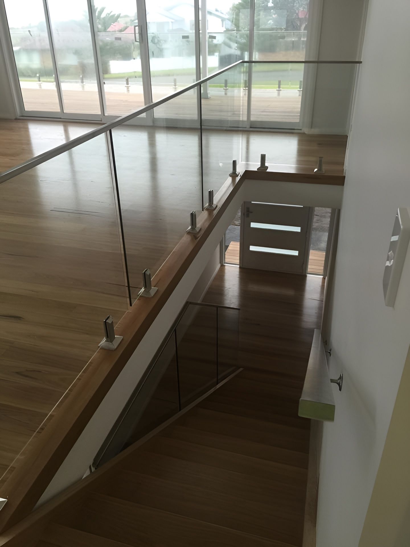 Wooden Staircase with Glass Railing, Leading to A Lower Level — Master Glass & Glazing in Belmont, NSW