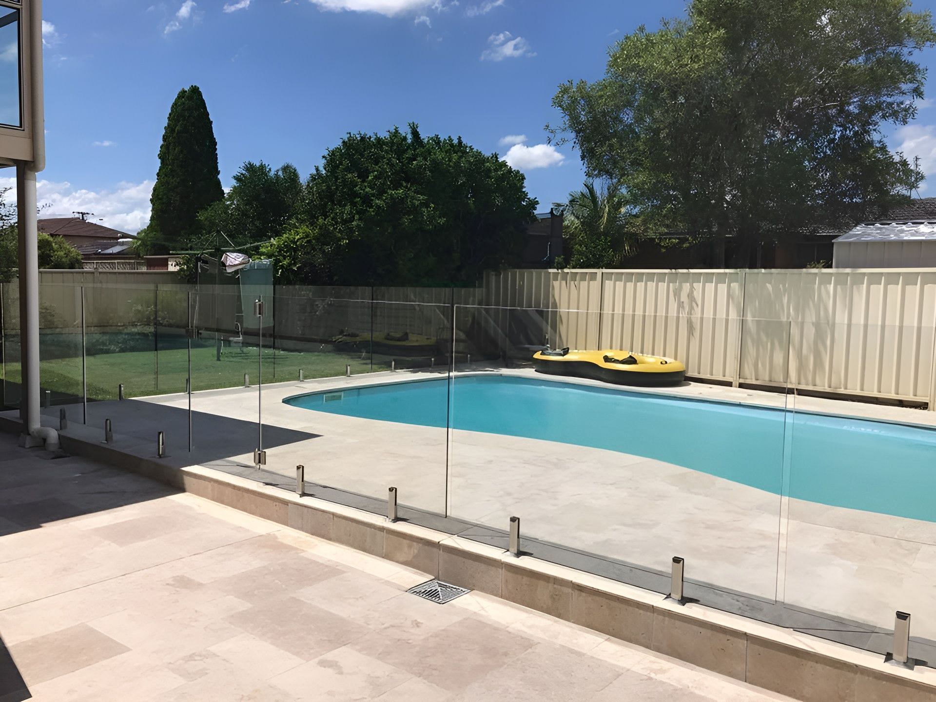 Backyard Pool with Glass Fencing, Light-Colored Patio — Master Glass & Glazing in Charlestown, NSW