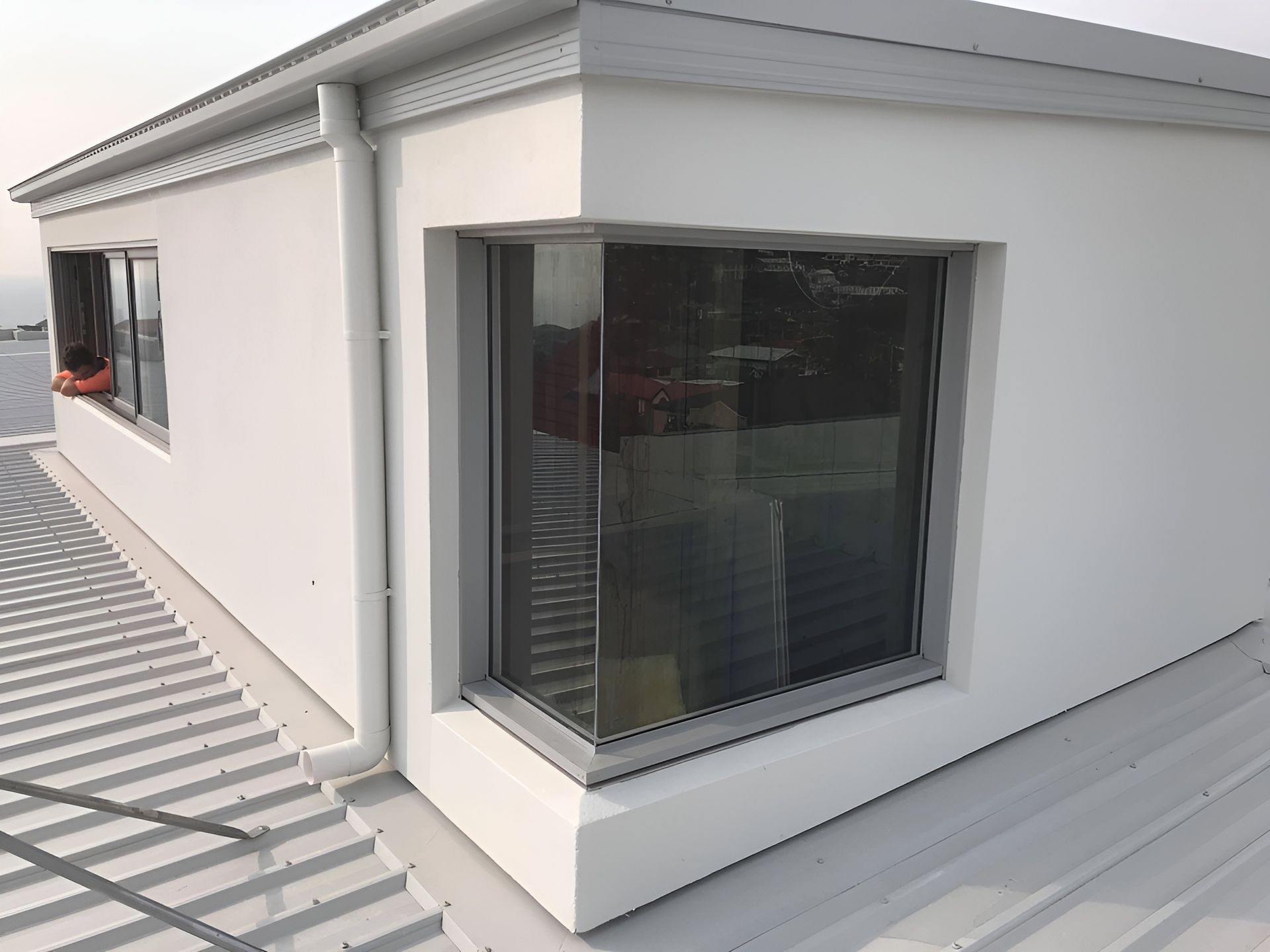 White Building with Corner Window and Metal Roof — Master Glass & Glazing in Newcastle, NSW